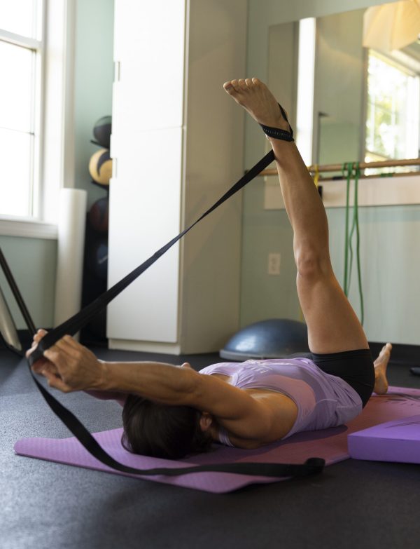 yoga stretch using mobility strap